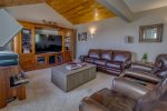 Main floor office and family room with large tv and leather couches/reclining chairs